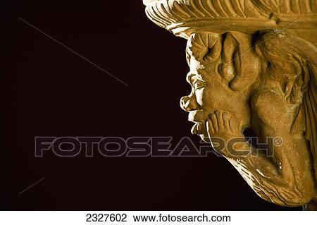 Close up of the profile of a lit gargoyle with a black background; Calgary alberta canada View Large Photo Image Stock Image - Close up of the profile of a lit gargoyle with a black background; Calgary alberta canada. Fotosearch