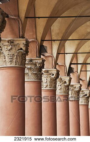 Stock Photography - Close Up Of The Tops Of A Row Of Corinthian Columns Within A Colonnade; Bologna Emilia-Romagna Italy. Fotosearch