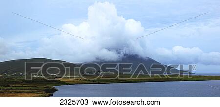 Clouds over the hills along the coast; Achill island county mayo ireland View Large Photo Image Stock Image - Clouds over the hills along the coast; Achill island county mayo ireland. Fotosearch