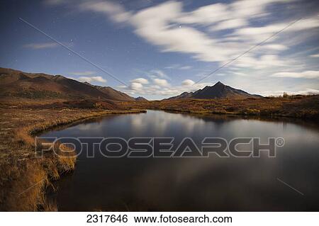 Clouds Reflected In A Small Pond Along The Dempster Highway And Landscape; Yukon Canada View Large Photo Image Stock Photograph - Clouds Reflected In A Small Pond Along The Dempster Highway And Landscape; Yukon Canada. Fotosearch