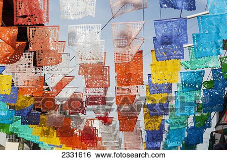 Stock Photograph - Colourful mexican fiesta flags decorate a street; Puerto vallarta mexico. Fotosearch