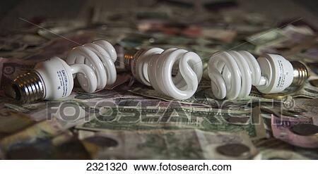 Compact Florescent Lightbulbs Sitting On American Money View Large Photo Image Stock Image - Compact Florescent Lightbulbs Sitting On American Money. Fotosearch