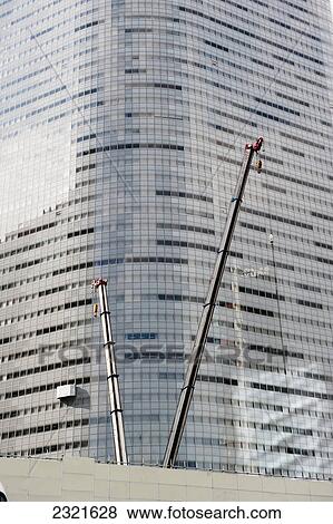 Stock Photo - Cranes Beside A Skyscraper; Tokyo Japan. Fotosearch