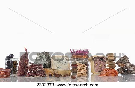 Deli meats and cheeses on a white background View Large Photo Image Stock Image - Deli meats and cheeses on a white background. Fotosearch