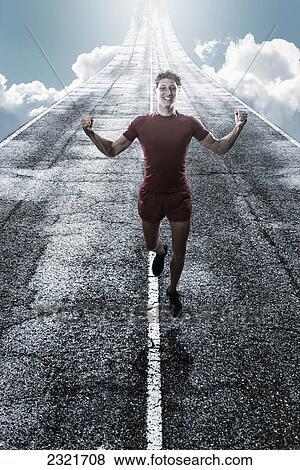 Stock Photo - Digital Composite Of A Man Running Down A Wet Road With Sunlight Illuminating Him; Tarifa Cadiz Andalusia Spain. Fotosearch