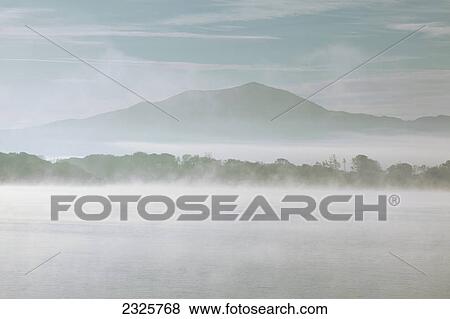 Stock Photo - Early morning mist over lough leane; Killarney county kerry ireland. Fotosearch
