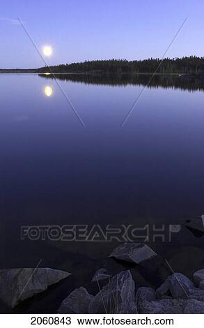 Stock Image - Early October Moonrise Over Pontoon Lake, Which Is Located Down The Ingraham Trail In Northwest Territories, Canada.. Fotosearch