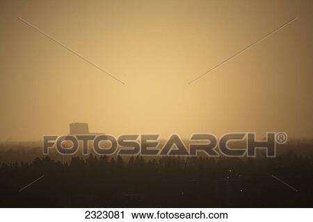 Stock Image - Evening light glowing through a heavy rain over a city; Edmonton alberta canada. Fotosearch
