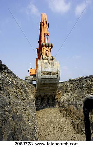 Stock Image - Excavator Filling In Section Of Drainage Pipe With Dirt; Canada, Ontario, Hamilton (Composting Facility). Fotosearch