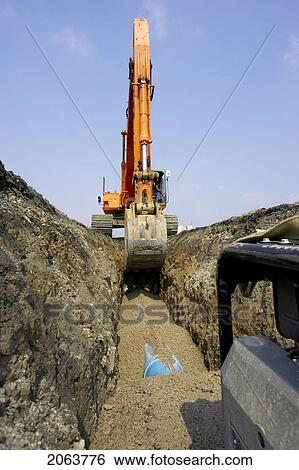 Stock Photograph - Excavator Filling In Section Of Drainage Pipe With Dirt; Canada, Ontario, Hamilton (Composting Facility). Fotosearch
