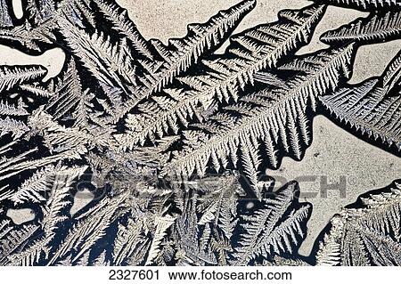 Stock Image - Extreme close up of frost patterns on a window; Calgary alberta canada. Fotosearch