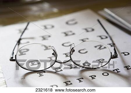 Stock Photo - Eyeglasses Resting On A Vision Testing Chart; Edmonton Alberta Canada. Fotosearch