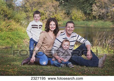 Stock Photography - Family portrait in a park in autumn; St. albert alberta canada. Fotosearch
