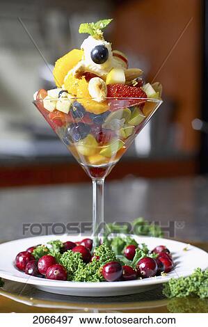 Stock Photo - Festive Fruit Cocktail With Mascarpone Cheese In A Martini Glass Garnished With Cranberries. Fotosearch