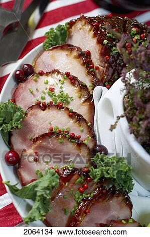 Festive Oven Roasted Ham Sliced And Garnished With Chives And Cranberries View Large Photo Image Picture - Festive Oven Roasted Ham Sliced And Garnished With Chives And Cranberries. Fotosearch