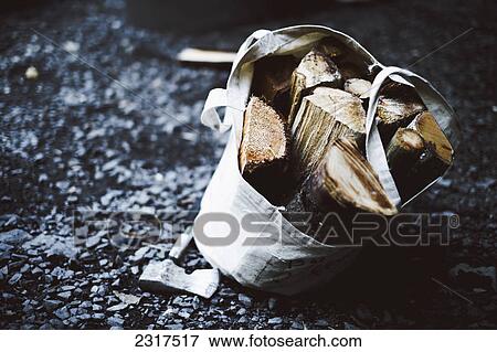 Firewood In A Canvas Bag With Hatchet On The Ground; Thetford Mines Quebec Canada View Large Photo Image Stock Photo - Firewood In A Canvas Bag With Hatchet On The Ground; Thetford Mines Quebec Canada. Fotosearch