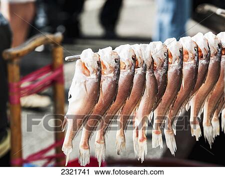 Stock Image - Fish Hanging On Display At A Fish Market; Busan South Korea. Fotosearch