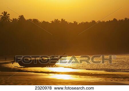 Fishing Boat At Sunset On Palolem Beach; Goa Karnataka India View Large Photo Image Stock Photo - Fishing Boat At Sunset On Palolem Beach; Goa Karnataka India. Fotosearch
