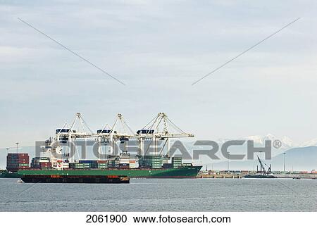 Stock Image - Freighters Load Up With Cargo At The Delta, Bc Port. Fotosearch