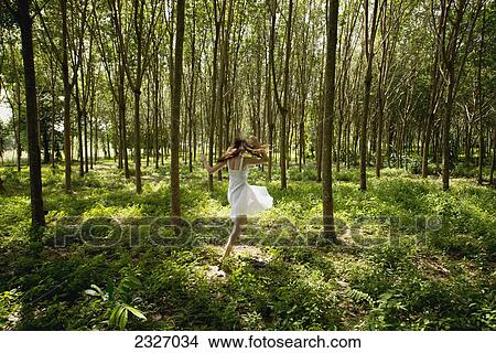 Girl dancing in the woods; Phuket thailand View Large Photo Image Picture - Girl dancing in the woods; Phuket thailand. Fotosearch