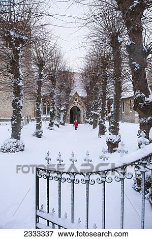 Girl walking up a path leading to a church in the snow; Great wilbraham cambridgeshire england View Large Photo Image Stock Photo - Girl walking up a path leading to a church in the snow; Great wilbraham cambridgeshire england. Fotosearch