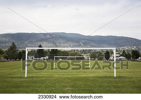 Goal posts in a row in a grass recreation field; British columbia canada View Large Photo Image Picture - Goal posts in a row in a grass recreation field; British columbia canada. Fotosearch