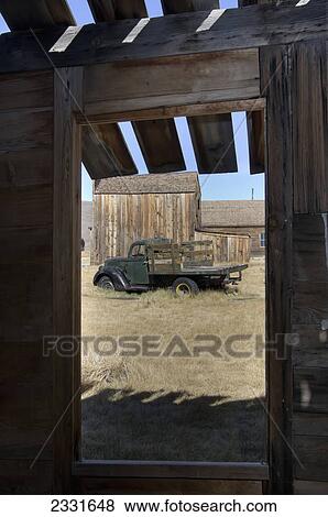 Gold mining ghost town and old truck framed through window of barn; Bodie california united states of america View Large Photo Image Stock Photo - Gold mining ghost town and old truck framed through window of barn; Bodie california united states of america. Fotosearch