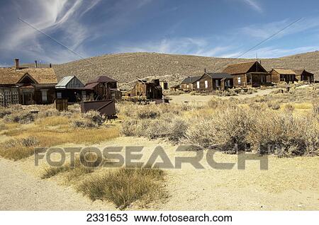 Stock Image - Gold mining ghost town with weathered buildings in the sage brush; Bodie california united states of america. Fotosearch