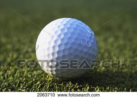Stock Image - Golf Ball On Organic Golf Course; Canada, Manitoba, Riding Mountain National Park. Fotosearch