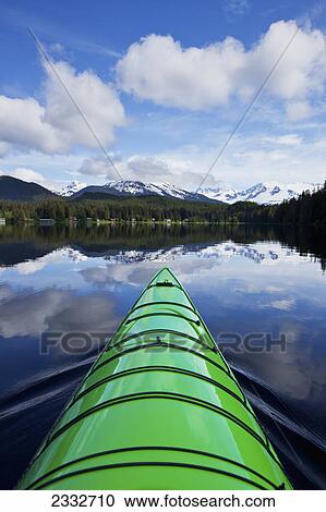 Green kayak on the tranquil water of auke lake with mendenhall glacier and towers in the distance; Alaska united states of america View Large Photo Image Stock Image - Green kayak on the tranquil water of auke lake with mendenhall glacier and towers in the distance; Alaska united states of america. Fotosearch