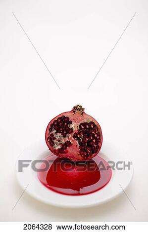 Stock Photo - Half A Pomegranate On A White Plate. Fotosearch