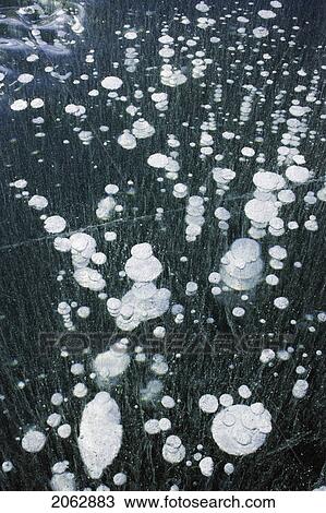 Stock Image - Ice Bubbles In Ice On Ghost Dam - Alberta Canada. Fotosearch