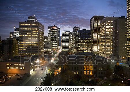 Illuminated road and buildings at night; Calgary alberta canada View Large Photo Image Stock Photo - Illuminated road and buildings at night; Calgary alberta canada. Fotosearch