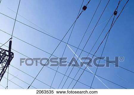 Stock Photography - Jet Contrail In Midst Of Electric Lines; Canada, Ontario. Fotosearch