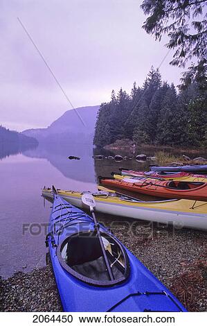 Stock Image - Kayaks Rest By The Shore Of Loon Lake, Early Fall Morning, Loon Lake, Near Maple Ridge, Bc. Fotosearch