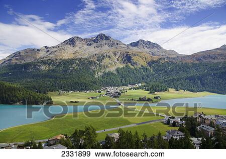 Lake silvaplana and the town with mountains in the background; Silvaplana grisons switzerland View Large Photo Image Stock Photo - Lake silvaplana and the town with mountains in the background; Silvaplana grisons switzerland. Fotosearch