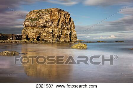 Large Rock Formation On The Coast Reflected In The Wet Sand; South Shields Tyne And Wear England View Large Photo Image Stock Photo - Large Rock Formation On The Coast Reflected In The Wet Sand; South Shields Tyne And Wear England. Fotosearch