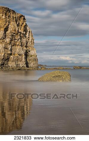 Large Rock Formation Reflected In The Shallow Water Along The Coast; South Shields Tyne And Wear England View Large Photo Image Stock Image - Large Rock Formation Reflected In The Shallow Water Along The Coast; South Shields Tyne And Wear England. Fotosearch