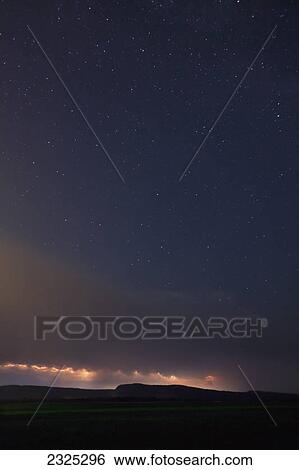 Stock Photograph - Lightning storm over the mountains with stars in the night sky; Thunder bay ontario canada. Fotosearch