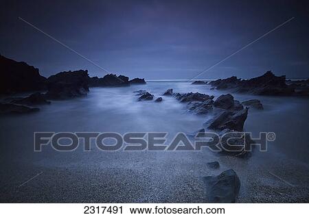 Long Exposure Of Rocks On The Beach At Night; Newquay Cornwall England View Large Photo Image Stock Image - Long Exposure Of Rocks On The Beach At Night; Newquay Cornwall England. Fotosearch