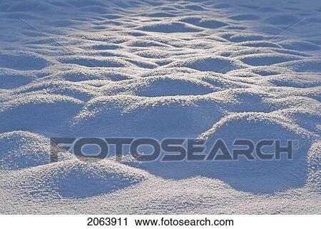 Stock Image - Low Winter Sun Lights Mounds Of Snow, Whistler, Bc. Fotosearch