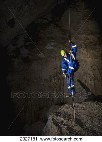 Male caver climbing a rope to exit a cave; Crowsnest pass alberta canada View Large Photo Image Stock Image - Male caver climbing a rope to exit a cave; Crowsnest pass alberta canada. Fotosearch