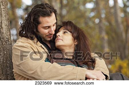 Stock Photo - Married couple in a romantic moment in a park in autumn; Edmonton alberta canada. Fotosearch