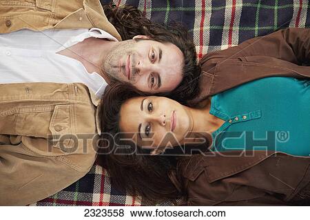 Married couple laying on a blanket; Edmonton alberta canada View Large Photo Image Stock Photo - Married couple laying on a blanket; Edmonton alberta canada. Fotosearch