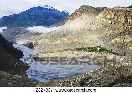Stock Photo - Morning sunlight fills mountains near chhusang (tsugsang) village; Upper mustang nepal. Fotosearch