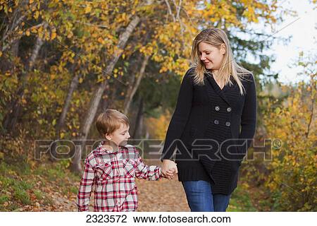 Mother and son walking on a path in a park in autumn; Edmonton alberta canada View Large Photo Image Stock Image - Mother and son walking on a path in a park in autumn; Edmonton alberta canada. Fotosearch