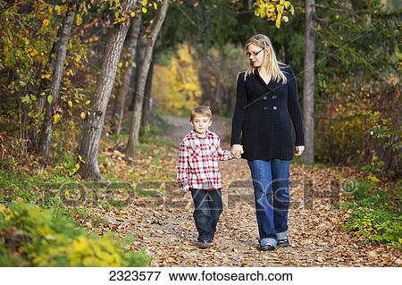 Mother and son walking on a path in a park in autumn; Edmonton alberta canada View Large Photo Image Stock Photo - Mother and son walking on a path in a park in autumn; Edmonton alberta canada. Fotosearch