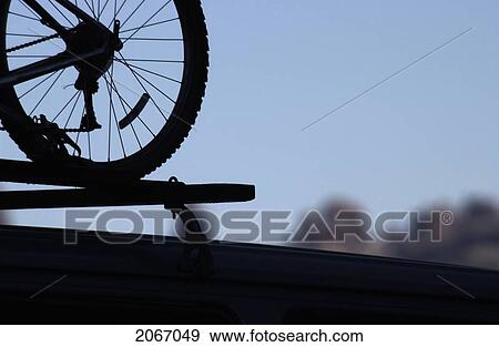 Mountain Bike Silhouette On The Roof Of A Car In Arches National Park Utah, View Large Photo Image Stock Photo - Mountain Bike Silhouette On The Roof Of A Car In Arches National Park Utah,. Fotosearch