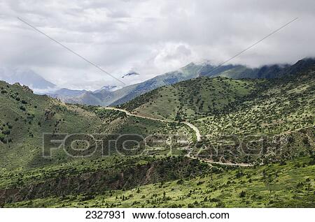 Stock Image - Mountainous landscape and road to the capital of nepalese upper mustang kingdom lo manthang; Upper mustang nepal. Fotosearch