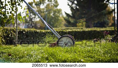 Stock Image - Mowing Lawn With A Reel Mower, For Exercise And To Reduce Energy Use, Regina, Saskatchewan. Fotosearch